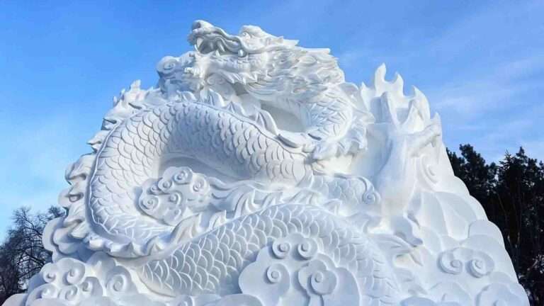 Read more about the article Participants At Winter Festival Carve Massive Dragon Sculpture